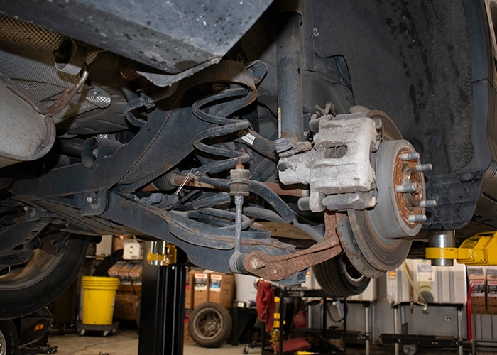 Close-up of a car's suspension system, featuring springs, shock absorbers
