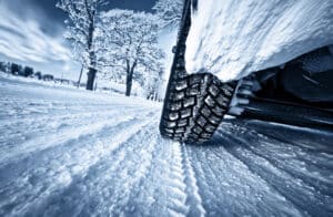 Snow tires vx all season tires at Accurate Automotive in Northglenn, CO. Image of car tires on winter road. | Accurate Automotive